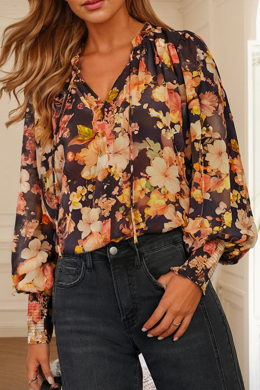 Zwarte luchtige blouse met bloemenprint, V-hals en pofmouwen